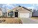 Charming single-story home featuring a well-manicured lawn and a convenient attached two-car garage at 504 Rhino Bnd, Oxford, NC 27565