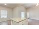 Kitchen island with granite countertop and a view of a bright, open-plan living space with large windows at 504 Rhino Bnd, Oxford, NC 27565