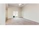 Spacious living room featuring a ceiling fan and sliding glass doors to the backyard, with carpet flooring at 504 Rhino Bnd, Oxford, NC 27565