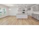 Open kitchen with granite island, modern appliances and ample counter space at 505 Providence Springs Ln, Fuquay Varina, NC 27526