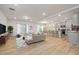 Bright and open living room with wood floors, cozy seating, and a modern kitchen at 505 Providence Springs Ln, Fuquay Varina, NC 27526