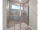 Modern tiled shower with glass enclosure and a built-in bench for a comfortable and luxurious bathing experience at 505 Providence Springs Ln, Fuquay Varina, NC 27526