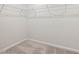 Empty walk-in closet ready for organization with wire shelving and neutral carpeting at 505 Providence Springs Ln, Fuquay Varina, NC 27526