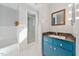Bathroom with a vanity featuring dark countertop, a shower, and tiled walls at 513 W Glendale St, Siler City, NC 27344