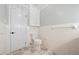 This bathroom features tiled walls, checkered floors, white fixtures, and a cabinet at 513 W Glendale St, Siler City, NC 27344