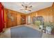 Unique bedroom with hardwood paneling, animal-themed murals, a ceiling fan and a blue area rug at 513 W Glendale St, Siler City, NC 27344