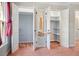 Walk-in closet complete with built-in shelving, dressing table, and storage for optimal organization at 513 W Glendale St, Siler City, NC 27344