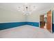Elegant dining room with carpet, wainscoting, crown molding and a modern chandelier at 513 W Glendale St, Siler City, NC 27344