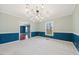 Elegant dining room with carpet, wainscoting, crown molding and a modern chandelier at 513 W Glendale St, Siler City, NC 27344