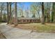 Charming brick home with a circular driveway and mature trees in a serene setting at 513 W Glendale St, Siler City, NC 27344