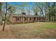 Side view of brick ranch with mature trees on a spacious lot at 513 W Glendale St, Siler City, NC 27344