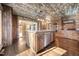Island kitchen with stainless steel appliances, brick accents, and custom cabinetry at 513 W Glendale St, Siler City, NC 27344