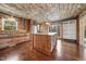Rustic kitchen boasts custom wood cabinets and island with granite countertops at 513 W Glendale St, Siler City, NC 27344