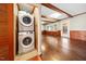 Convenient laundry area featuring stacked washer and dryer units, adjacent to a spacious living area at 513 W Glendale St, Siler City, NC 27344