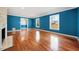 Inviting living room features hardwood floors, natural light from large windows, and a fireplace with stone surround at 513 W Glendale St, Siler City, NC 27344