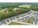 Aerial view of a residential neighborhood with neatly landscaped yards and tree-lined streets near fields at 622 Lone Pine Loop, Fuquay Varina, NC 27526