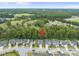 Aerial view of home and neighborhood surrounded by lush greenery and green open spaces at 622 Lone Pine Loop, Fuquay Varina, NC 27526