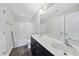 Bathroom features dual sinks, a large mirror, a shower, and dark hardwood-style floors at 622 Lone Pine Loop, Fuquay Varina, NC 27526