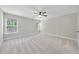 Well-lit bedroom with a ceiling fan and large windows offering serene views at 622 Lone Pine Loop, Fuquay Varina, NC 27526