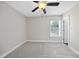 Neutral bedroom with carpet, ceiling fan, window, and white trim at 622 Lone Pine Loop, Fuquay Varina, NC 27526