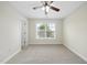 Charming bedroom features with natural light from a bright window, and a modern ceiling fan for comfort at 622 Lone Pine Loop, Fuquay Varina, NC 27526
