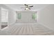 Bright bedroom with natural light, featuring a ceiling fan, and neutral color scheme at 622 Lone Pine Loop, Fuquay Varina, NC 27526