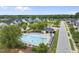 A community pool is showcased in this aerial shot, including a grassy park and rows of houses at 622 Lone Pine Loop, Fuquay Varina, NC 27526