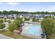 Aerial view of a community pool surrounded by lush landscaping and homes, perfect for summer enjoyment at 622 Lone Pine Loop, Fuquay Varina, NC 27526