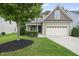 Lovely home exterior featuring well maintained lawn and attached garage at 622 Lone Pine Loop, Fuquay Varina, NC 27526