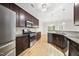 Modern kitchen boasts stainless steel appliances, dark wood cabinetry, and sleek countertops at 622 Lone Pine Loop, Fuquay Varina, NC 27526