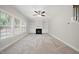 Cozy living room with plush carpeting, fireplace, built-ins, and large windows provide comfort at 622 Lone Pine Loop, Fuquay Varina, NC 27526