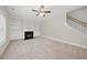 Comfortable carpeted living area with a fireplace and built-in shelving provides storage at 622 Lone Pine Loop, Fuquay Varina, NC 27526