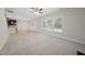 Open-concept area with carpet, and a kitchen view brings natural light and inviting living at 622 Lone Pine Loop, Fuquay Varina, NC 27526