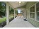 The covered patio features screen walls and a ceiling fan at 622 Lone Pine Loop, Fuquay Varina, NC 27526