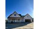 New home under construction featuring a covered front porch, a two-car garage, and architectural roof design at 6312 River Rd, Fuquay Varina, NC 27526
