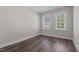 Well lit bedroom featuring wood-look flooring, neutral walls and two windows with privacy blinds at 716 Jamescroft Way # 28, Rolesville, NC 27571