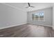 Spacious bedroom featuring wood-look flooring, a ceiling fan, and a bright window with privacy blinds at 716 Jamescroft Way # 28, Rolesville, NC 27571