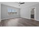 Bright bedroom with wood-look flooring, ceiling fan, and ensuite bathroom with shaker cabinets at 716 Jamescroft Way # 28, Rolesville, NC 27571
