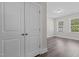 Bright bedroom with wood-look flooring, view of two windows, and large closet door at 716 Jamescroft Way # 28, Rolesville, NC 27571