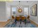Dining room features contemporary decor, natural light, a modern chandelier, and a table set for a meal at 716 Jamescroft Way # 28, Rolesville, NC 27571