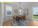 Charming dining room showcasing natural light, a modern chandelier, and stylish furniture for comfortable entertaining at 716 Jamescroft Way # 28, Rolesville, NC 27571