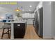 Modern kitchen features white cabinetry, stainless steel appliances, a center island, and seamlessly opens to the living area at 716 Jamescroft Way # 28, Rolesville, NC 27571