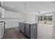 Modern kitchen with stainless steel appliances, gray island, and sliding glass doors to back yard at 716 Jamescroft Way # 28, Rolesville, NC 27571