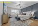 Serene primary bedroom features a decorative accent wall, ceiling fan, and stylish furniture for a tranquil retreat at 716 Jamescroft Way # 28, Rolesville, NC 27571