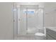 Tiled shower with frameless glass doors and shower bench; sky light adds natural light at 716 Jamescroft Way # 28, Rolesville, NC 27571