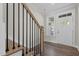 Staircase shot featuring wood treads, black railings, with natural light and a white front door at 716 Jamescroft Way # 28, Rolesville, NC 27571