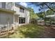 This backyard has a sliding glass door leading to the house and a wooden fence at 7708 Falcon Rest Cir, Raleigh, NC 27615