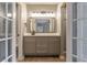 Modern bathroom featuring a vanity with brushed hardware, a mirror, and tiled flooring at 7708 Falcon Rest Cir, Raleigh, NC 27615