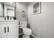 Contemporary powder room featuring a sleek white vanity and modern fixtures at 7708 Falcon Rest Cir, Raleigh, NC 27615