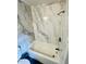 Updated bathroom with marble shower walls and black shower head at 7708 Falcon Rest Cir, Raleigh, NC 27615
